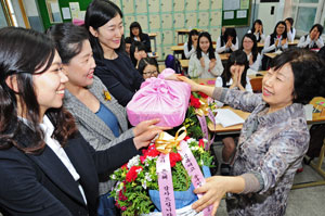 스승의 날을 나흘 앞둔 11일 경북여고 졸업생인 중구청 직원들(왼쪽)이 모교를 방문해 선생님께 꽃바구니를 드리며 스승의 은혜에 감사하고 있다. 대구 중구청은 스승의 날을 앞두고 직원들의 