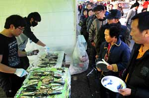 구룡포 과메기 축제장을 찾은 많은 관람객들이 과메기 재료로 사용되는 꽁치구이를 시식하기 위해 길게 줄지어 서 있다. 구룡포 바다에서 맛보는 꽁치구이는 겨울 미식가들의 입맛을 돋우는 원천이다. 성일권기자 sungig@msnet.co.kr