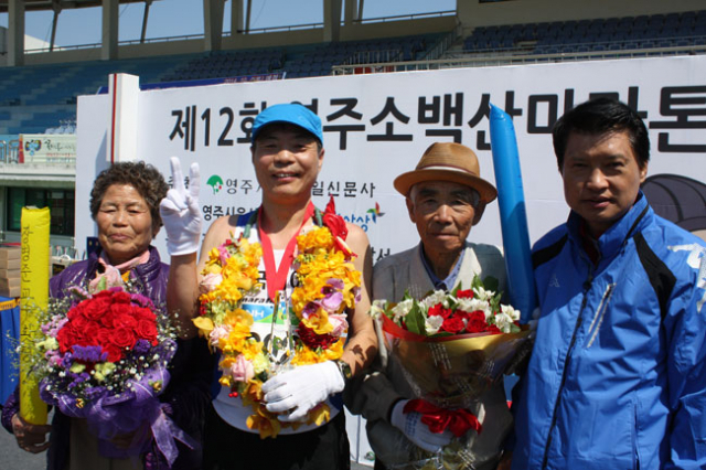 6일 열린 영주 소백산마라톤대회에서 완주 100회를 달성한 장병준 씨. 그는 자신의 부모님, 안효종 영주시장 권한대행 등과 함께 기념촬영을 하며 기쁨을 나눴다. 전종훈 기자