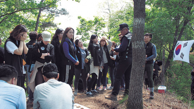 ▲6·25전쟁 다부동전투 유해발굴 현장 봉사활동에 나선 대구예술대 학생들이 발굴된 유품과 유해를 바라보고 있다. 대구예술대 제공