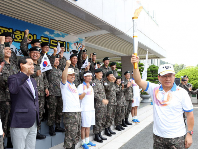 30일 오전 경북 문경 세계군인체육대회의 경호경비작전사령부인 제2작전사령부에 성화가 도착했다. 박찬주(사진 오른쪽) 사령관이 성화를 높이 들고 장병들과 함께 파이팅을 외치고 있다. 제2작전사령부 제공