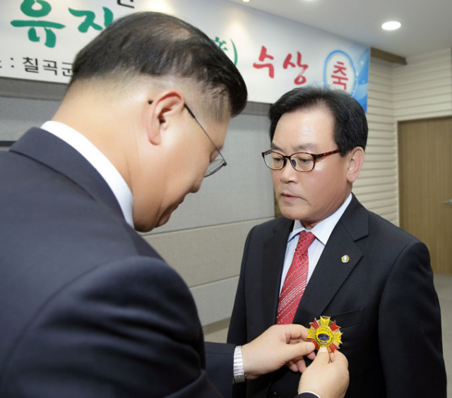 허준영(왼쪽) 한국자유총연맹 총재가 백선기 칠곡군수에게 세계자유민주연맹 자유장 을 달아주고 있다. 칠곡군 제공