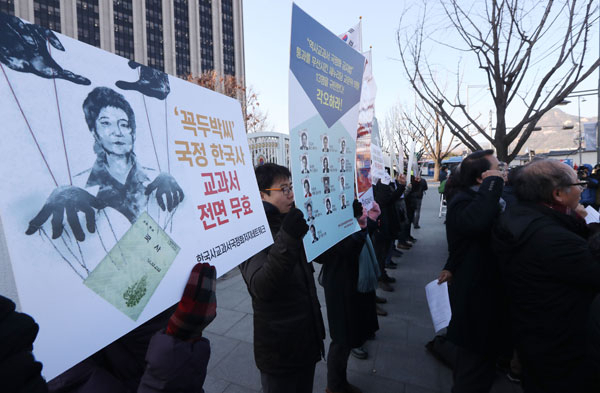 국정 역사교과서 현장 검토본과 집필진이 공개된 28일 오후 서울 세종로 정부서울청사 앞에서 한국사교과서국정화저지네트워크 회원들이 역사 교과서 국정화 