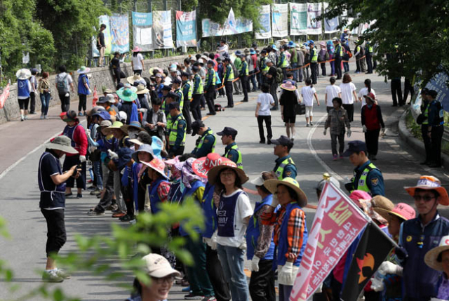 13일 오후 사드가 배치된 경북 성주골프장 인근 진밭교 삼거리에서 열린 불법사드 원천무효 제3차 소성리 범국민 평화행동에서 참가자들이 손을 잡고 인간띠 잇기를 하고 있다. 연합뉴스