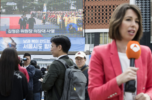 27일 오전 서울 시청광장에 설치된 대형 스크린 앞에서 외신기자가 남북 정상회담 생중계를 보도하고 있다. 연합뉴스