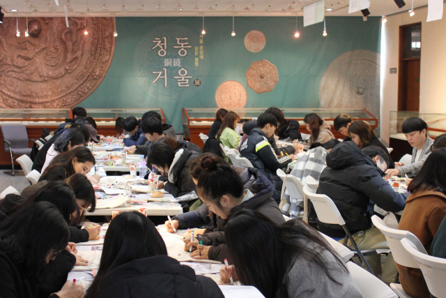 대구가톨릭대학교 학생들이 대학 역사‧박물관에서 민화 에코백 만들기 체험을 하고 있다. 대구가톨릭대 제공