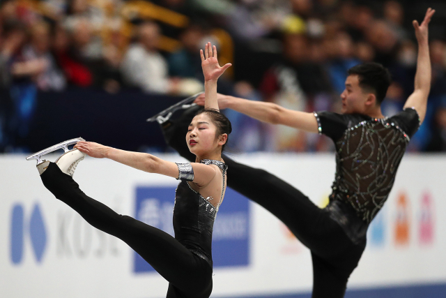 SAITAMA, JAPAN - MARCH 20, 2018: Figure skaters Kim Ju Sik and Ryom Tae Ok of North Korea perform during the pairs\