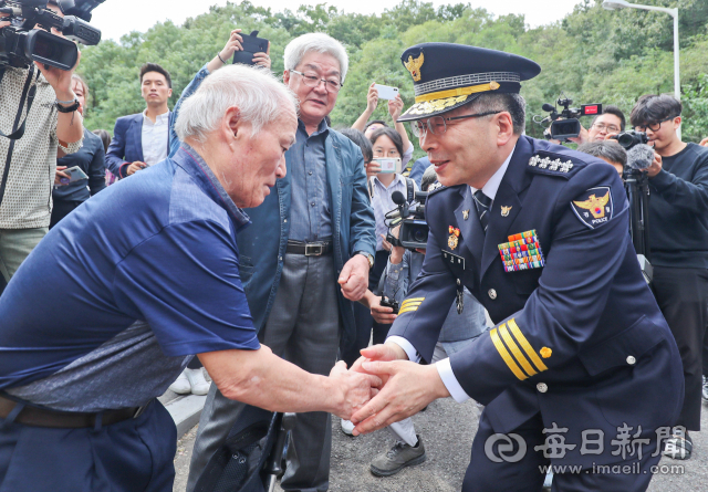 20일 대구 달서구 와룡산 세방골 개구리소년 유골 발견 현장을 찾은 민갑룡 경찰청장이 희생자 김영규(당시 11세)군의 아버지 김현도 씨의 손을 잡고 있다. 민 청장은 