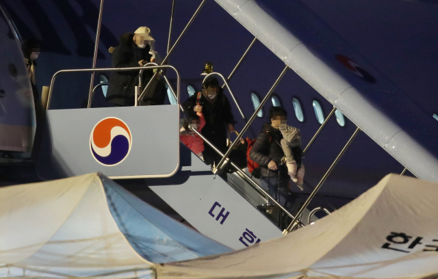 중국 후베이성 우한에 거주 중인 교민들이 12일 김포공항을 통해 귀국해 전세기에서 내리고 있다. 연합뉴스