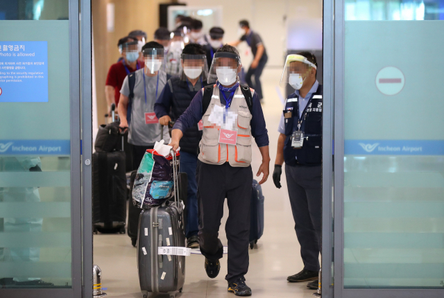 31일 오전 인천국제공항을 통해 귀국한 이라크 건설 현장 파견 근로자들이 공항 청사를 나서고 있다. 탑승 전 미리 실시한 코로나19 진단검사에서 양성 판정을 받은 근로자들은 의료기관 또는 생활 치료센터에 이송돼 치료를 받게 되며 음성 판정을 받은 경우 임시 생활시설에서 2주 동안 격리된다. 연합뉴스