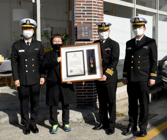 12일 해군 6항공전단이 6·25전쟁 참전용사 고 윤병재 중사의 유가족에게 무성화랑 훈장을 전수하고 있다. 해군 6항공전단 제공