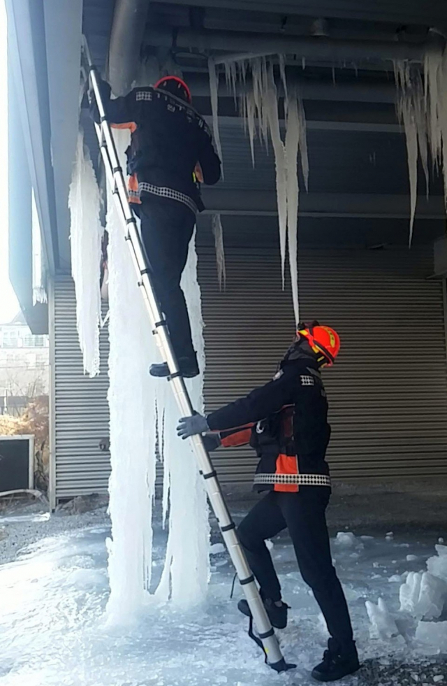 7일 강원도소방본부에 따르면 한파경보가 내려진 지난달 20일 이후 현재까지 한랭질환 18건, 동파나 결빙으로 인한 식수 지원 9건, 고드름 제거 8건이 발생했다. 사진은 고드름 제거하는 소방대원들. 연합뉴스