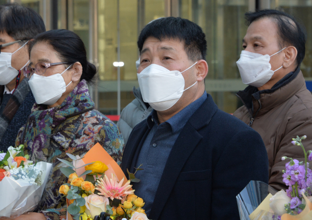 17일 오후 경기도 수원시 영통구 수원지방법원에서 열린 이춘재 연쇄살인 8차 사건 재심 선고공판에서 재심 청구인 윤성여 씨가 무죄를 선고받고 법원 청사를 나와 지인들의 축하를 받고 있다. 연합뉴스