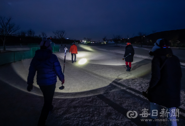 대구 북구 검단동 금호강 변 파크골프장에 나온 어르신들이 헤드랜턴 불빛으로 페어웨이를 걷고 있다. 김태형 선임기자 thk@imaeil.com