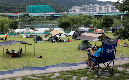 지난해 7월 대구 북구 금호강산격야영장에서 시민들이 텐트를 설치한 채 캠핑을 즐기고 있다. 코로나19 여파로 물놀이장보다는 사회적 거리두기가 최적화된 야영장과 캠핑장을 찾는 시민들이 늘고 있다. 우태욱 기자 woo@imaeil.com