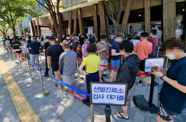 12일 오전 서울 송파구 송파보건소 선별진료소에서 시민들이 검사를 받기 위해 줄을 서있다. 중앙방역대책본부는 이날 0시 기준 신규 확진자가 1천755명 늘어 누적 27만2천982명이라고 밝혔다. 연합뉴스