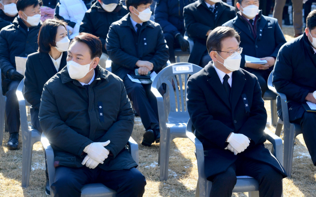 더불어민주당 이재명 대선후보와 국민의힘 윤석열 대선후보가 19일 서울 용산구 효창공원에서 엄수된 매헌 윤봉길 의사 순국 89주기 추모식에서 황기철 국가보훈처장의 추모사를 듣고 있다. 연합뉴스