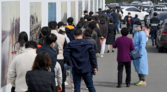 전국 코로나19 신규확진자가 38만명을 넘어서며 역대 최대치를 기록한 12일 오전 대구 달서구 두류정수장 코로나19 임시선별검사소에서 시민들이 PCR검사를 받기 위해 긴 줄을 서고 있다. 김영진 기자 kyjmaeil@imaeil.com