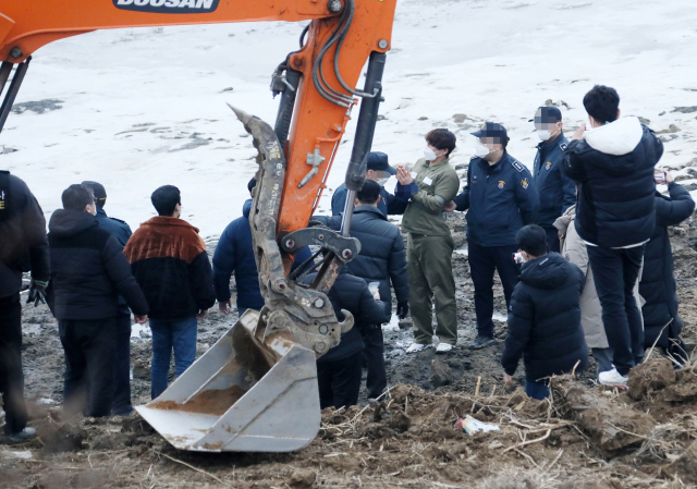 택시 기사와 동거녀를 살해한 혐의로 구속된 이기영이 6일 오후 경기도 파주 공릉천변에서 검찰 관계자들과 현장검증을 하고 있다. 연합뉴스