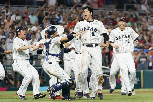 Japan players celebrate after defeating the United States in the World Baseball Classic championship game, Tuesday, March 21, 2023, in Miami. (AP Photo/Wilfredo Lee)