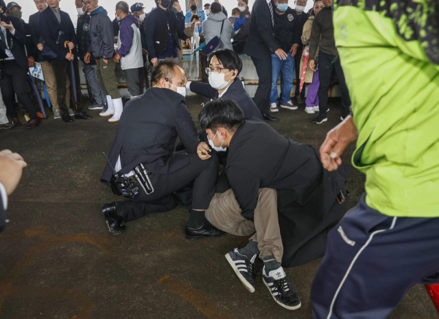 15일 오전 11시 30분께 기시다 후미오 일본 총리가 일본 와카야마(和歌山)현에서 현장 시찰을 마치고 연설을 시작하기 직전 폭발음을 야기시킨 물체를 던진 남성이 체포되고 있다. 연합뉴스