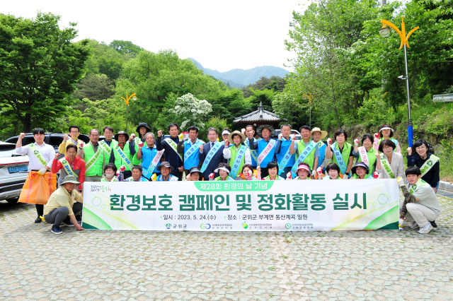 경북 군위군 3개 환경단체가 팔공산 동산계곡에서 환경보호 캠페인과 정화 활동을 펼치고, 기념 사진을 촬영하고 있다. 군위군 제공