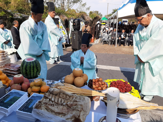 나정태(가운데) 한국전쟁 전후 경산코발트광산 민간인 희생자 유족회 이사장이 23일 경산코발트광산 민간인 희생자 제73주기 제24회 합동위령제에서 고인들에게 잔을 올린 후 추모하고 있다. 김진만 기자