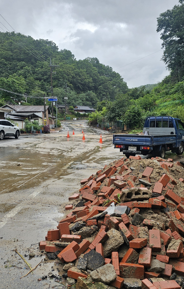 8일 밤 사이 많은 비가 쏟아지면서 안동시 용상 옛 성공동 일대 주택가 인도 보도블럭이 빗물에 쓸려 내려가 주택과 주차장 차량을 덮쳤다. 엄재진 기자