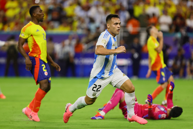 Jul 14, 2024; Miami, FL, USA; Argentina forward Lautaro Martinez (22) scores against Colombia during the second half of extra time of the Copa America final at Hard Rock Stadium. Mandatory Credit: Sam Navarro-USA TODAY Sports