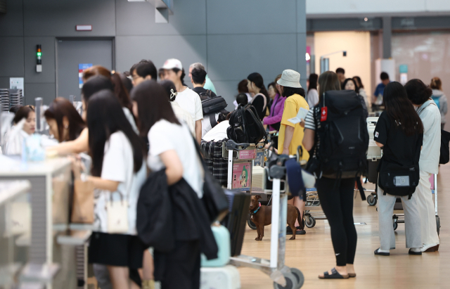 17일 인천국제공항 제2여객터미널 출국장에서 휴가철을 맞은 여행객들이 탑승 수속을 위해 이동하고 있다. 연합뉴스