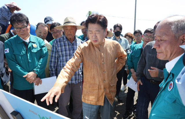 폭염과 가뭄으로 제주에서 농작물 피해가 발생하는 가운데 오영훈(오른쪽 두 번째) 도지사가 12일 오전 제주시 구좌읍 월정리의 급수 지원 현장을 찾아 관계자들과 이야기를 나누고 있다. 연합뉴스