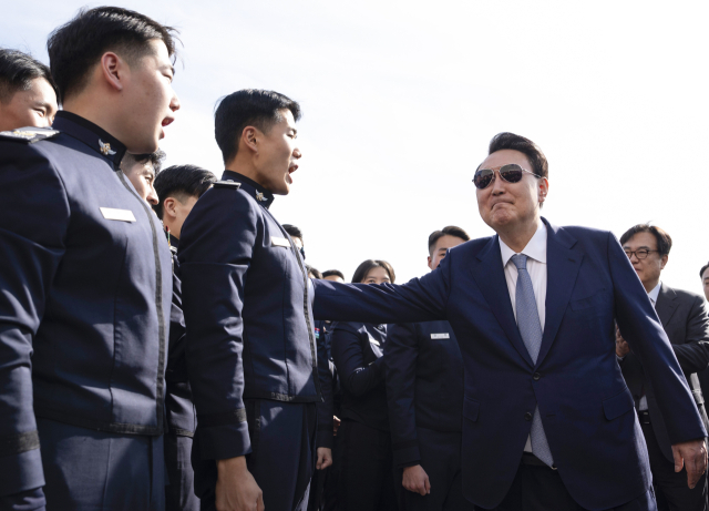 윤석열 대통령이 지난 25일 서울 용산 대통령실 앞에서 견학 온 공군사관학교 4학년 생도들을 만나 격려하고 있다. 연합뉴스