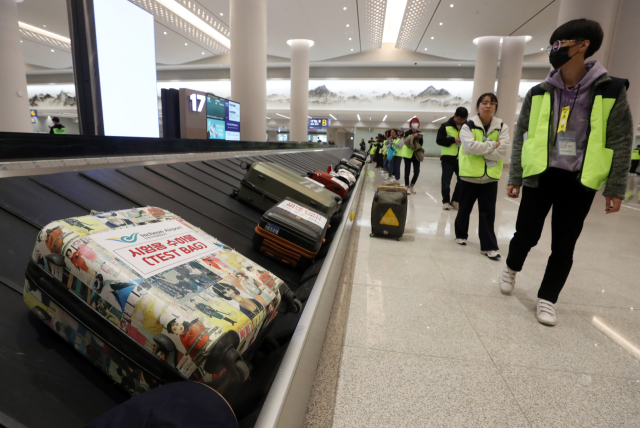 30일 인천공항 제2여객터미널 4단계 확장 현장에서 열린 종합시험운영에서 가상승객들이 수하물을 찾고 있다. 인천공항 4단계 확장 사업은 대부분 공사가 마무리돼 연내 운영을 시작할 계획이다. 연합뉴스