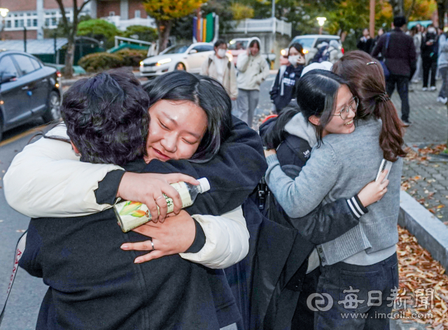 2025학년도 대학수학능력시험일인 14일 대구 수성구 정화여자고등학교에서 수능을 마친 수험생이 가족과 기쁨을 만끽하고 있다. 안성완 기자 asw0727@imaeil.com