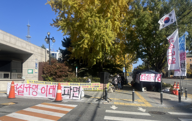 지난 22일 대구 달서구청 앞에서 죽전3구역재건축조합 정상화 대책위원회가 시위를 진행하는 모습. 붉은 글씨로 작성한 비방문이 구청 입구를 에워싸고 있다. 정두나 기자