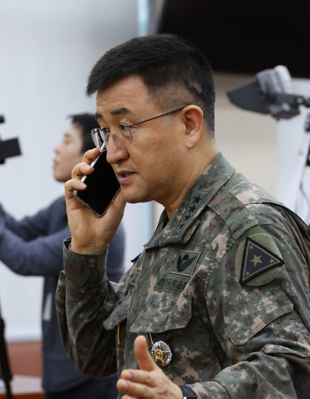 박안수 육군참모총장이 10일 오후 국회에서 열린 국방위원회 전체회의가 정회 되자 전화하고 있다. 연합뉴스