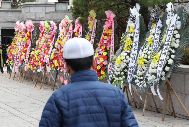 16일 오전 서울 종로구 헌법재판소 앞에 대통령 지지 화환(왼쪽)과 탄핵 촉구 근조화환(오른쪽)이 놓여 있다. 연합뉴스