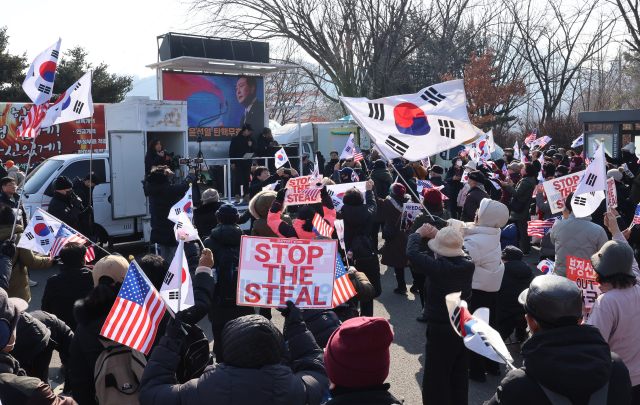 윤석열 대통령이 내란 우두머리 혐의로 고위공직자범죄수사처(공수처)에 체포된 지 사흘째인 17일 오전 경기도 의왕시 서울구치소 앞에서 열린 윤 대통령 지지자 집회에서 참가자들이 구호를 외치고 있다. 연합뉴스