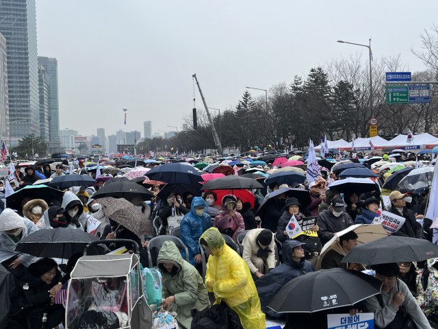 1일 오후 1시 서울 여의대로에서 탄핵 반대 집회가 열렸다. 이날 오후 2시 30분쯤부터 비가 오기 시작했지만 집회 참여자들은 우산이나 우비를 쓰고 자리를 지켰다. 정두나 기자