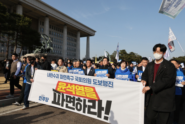 윤석열 대통령 파면 촉구 도보 행진에 참여한 더불어민주당 의원들이 13일 서울 여의도 국회에서 광화문을 향해 출발하고 있다. 연합뉴스