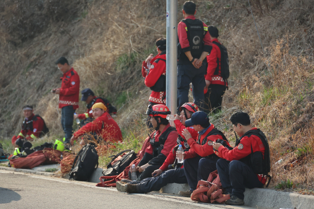 경남 산청군에서 발생한 산불 사흘째인 23일 시천면 야산에서 산불진화대원이 휴식을 취하고 있다. 연합뉴스